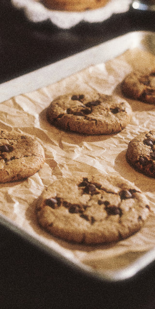 Chocolate chip cookies on a baking sheet with parchment paper
